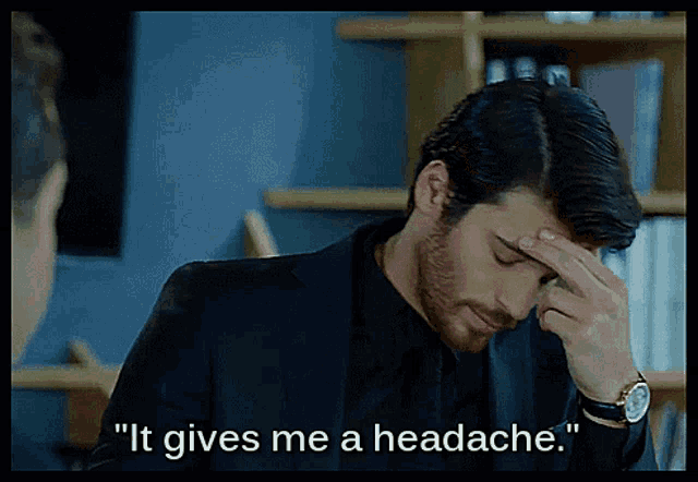 a man in a suit holds his hand to his forehead with the words " it gives me a headache " below him