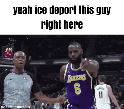 a basketball player wearing a lakers jersey is pointing at a referee