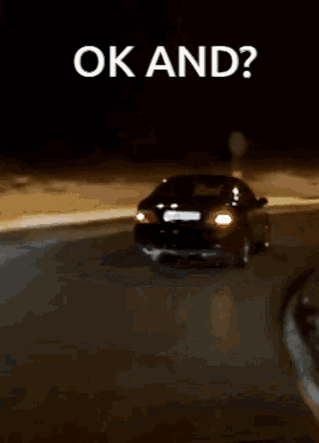 a car is driving down a road at night with the words ok and written above it