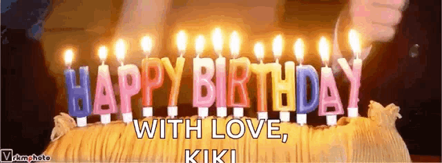 a birthday cake with candles that say happy birthday with love kiki