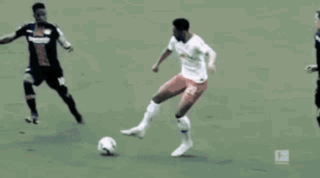 a soccer game is being played in a stadium with a banner that says 100 % bonus .