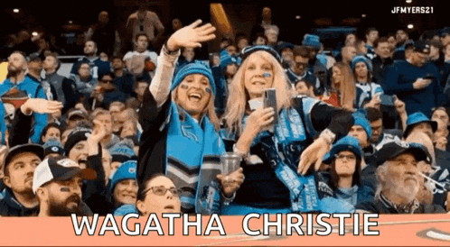 a crowd of people watching a game with the name wagatha christie on the top