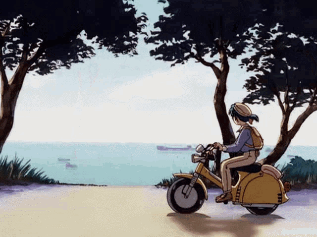a person riding a yellow scooter with the word yamaha on it