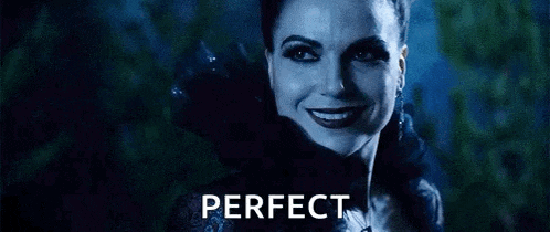 a woman in a black dress is smiling in front of a dark background and the word perfect is on the bottom .