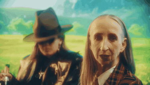 a woman in a hat stands next to an older woman in a plaid jacket
