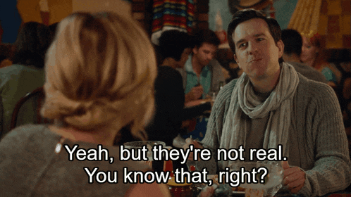 a man and woman are sitting at a table and the man is saying " yeah but they 're not real you know that right "