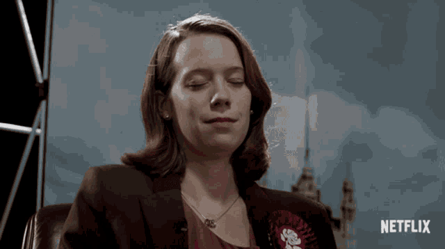 a woman with her eyes closed in front of a netflix ad