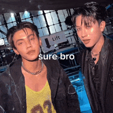 two men are standing next to each other with a sign that says lift in the background
