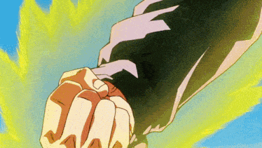 a close up of a person 's fist with a yellow light behind it