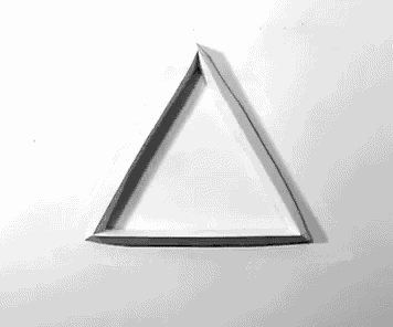 a black triangle on a white background with a shadow