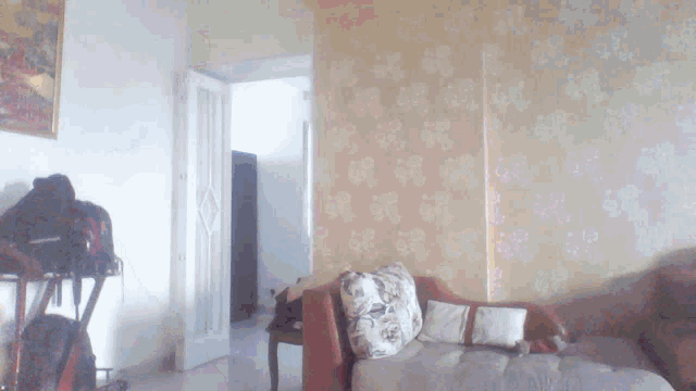 a living room with a couch and a painting on the wall behind it
