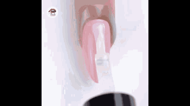 a close up of a nail being painted with a brush