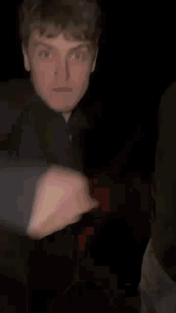 a person is holding a light in their hand in the dark