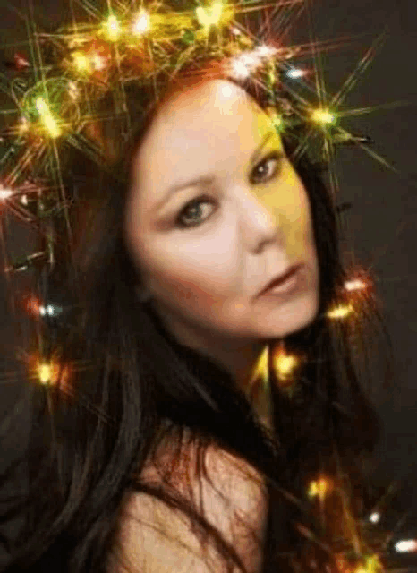 a woman is wearing a crown of christmas lights on her head