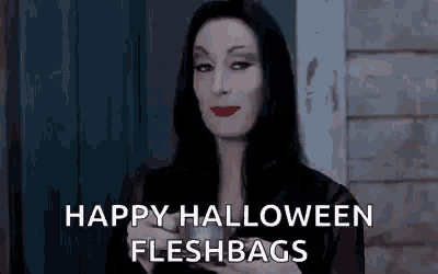 a woman dressed as morticia from the addams family is holding a cup of coffee and saying happy halloween fleshbags .