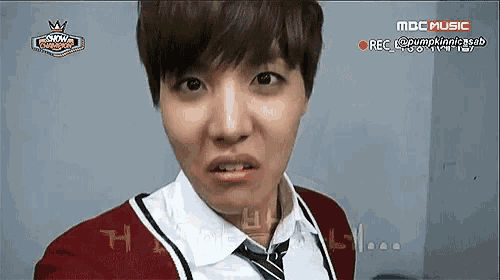 a close up of a person 's face with the words mbc music behind him