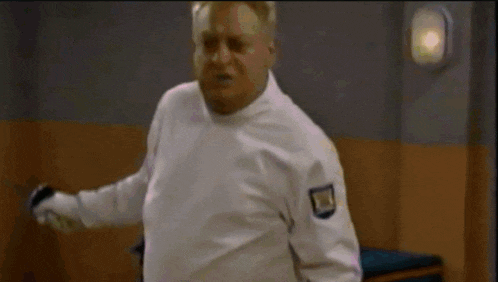 a man in a white uniform is holding a sword
