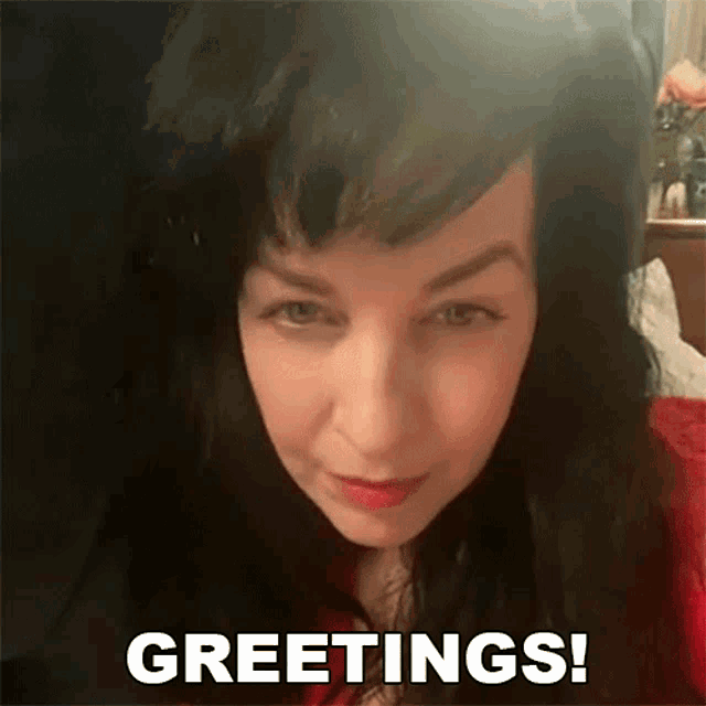a close up of a woman 's face with the words greetings behind her