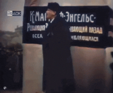 a man stands in front of a sign that says 24 ack on it