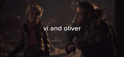 a group of people standing next to each other in a dark room with the words `` vi and oliver '' written above them .