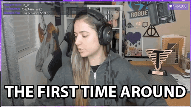 a woman wearing headphones says " the first time around " on a screen
