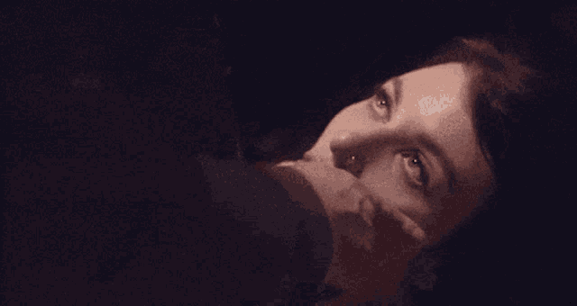 a man holds a woman 's face in his hand