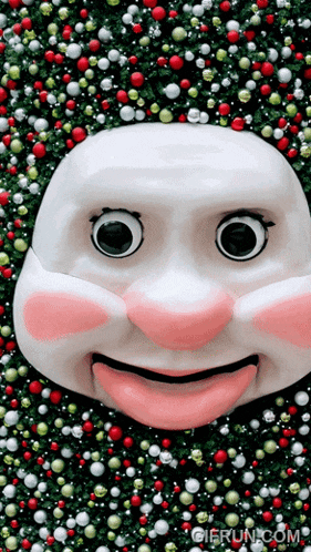 a gif from gierun.com shows a white face surrounded by christmas decorations