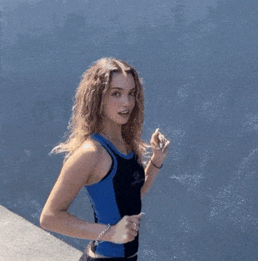 a girl wearing a tank top that says skechers