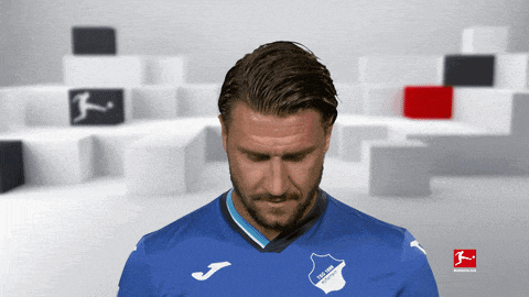 a man wearing a blue shirt that says tsg 1899 hoffenheim on it