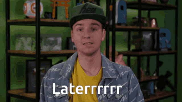 a man wearing a green hat and a yellow shirt says laterrrrr