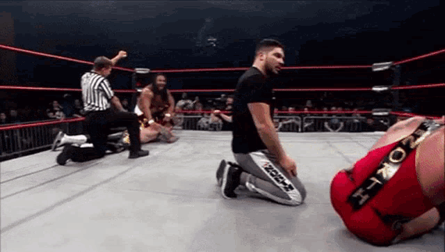 a wrestling ring with a referee and a wrestler wearing a pair of shorts that say ' brooklyn '
