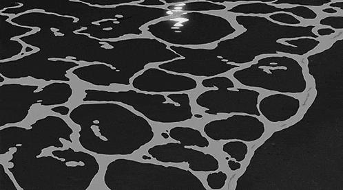 a black and white drawing of a wave breaking on the shore
