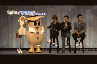 a group of men are sitting on stools in front of a mascot that says ' nightingale ' on it