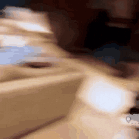 a blurry picture of a person 's face with a few spots of light on it