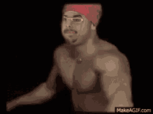 a shirtless man wearing a red bandana and sunglasses