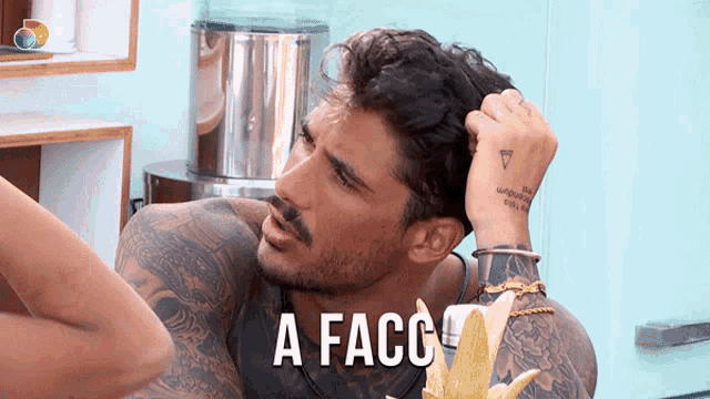 a man with a tattoo on his arm is scratching his head and the words a facc are above him