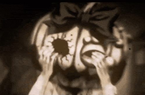 a close up of a pumpkin with a bow on it 's head