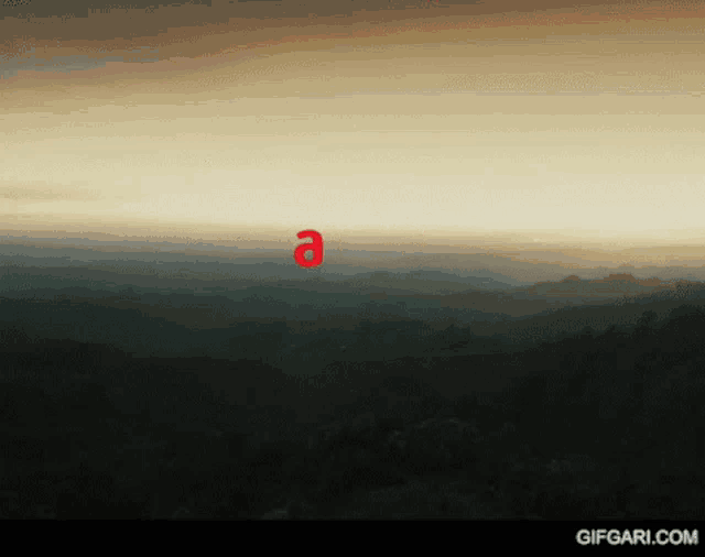 a red letter a is floating in the sky over a valley