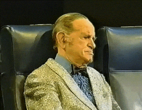 a man in a suit is sitting in a chair