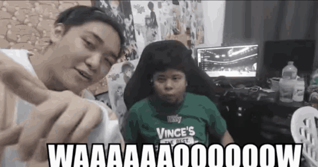 a boy wearing a green shirt that says vince 's