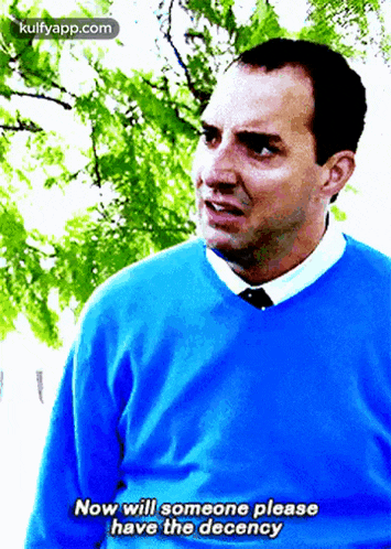 a man in a blue sweater and tie is saying now will someone please have the decency