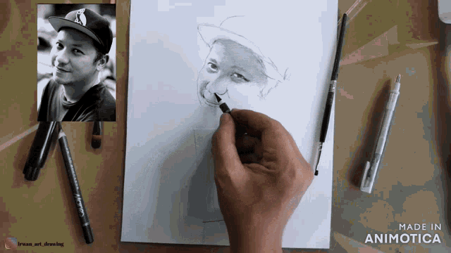 a person is drawing a picture of a boy with a hat