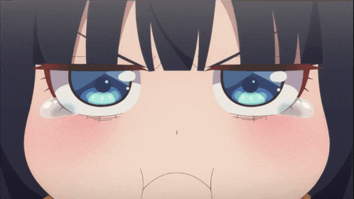 a close up of a girl 's face with a tear coming out of her eye