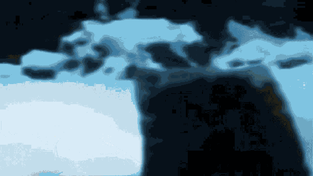 a blurry picture of a person standing in a snowy area