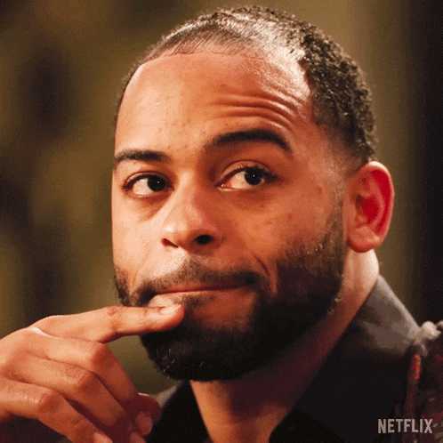 a close up of a man 's face with a netflix logo on the bottom right