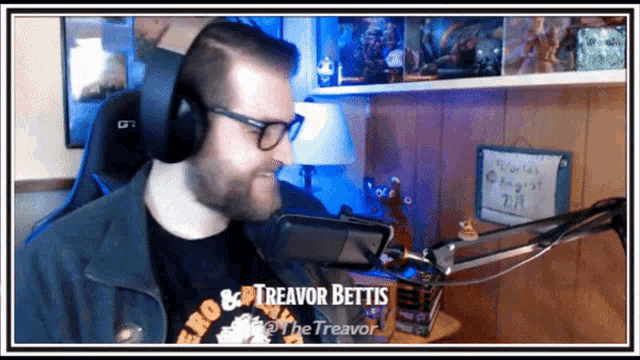 a man wearing headphones and a shirt that says " treavor bettis " on it