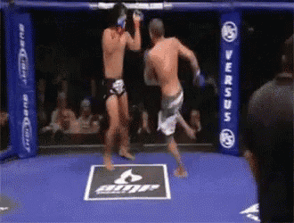 two men are fighting in a boxing ring with a blue banner that says versus