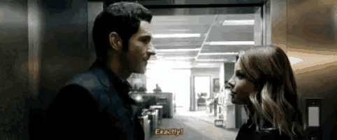 a man and a woman are standing next to each other in an elevator and the man is saying exactly .
