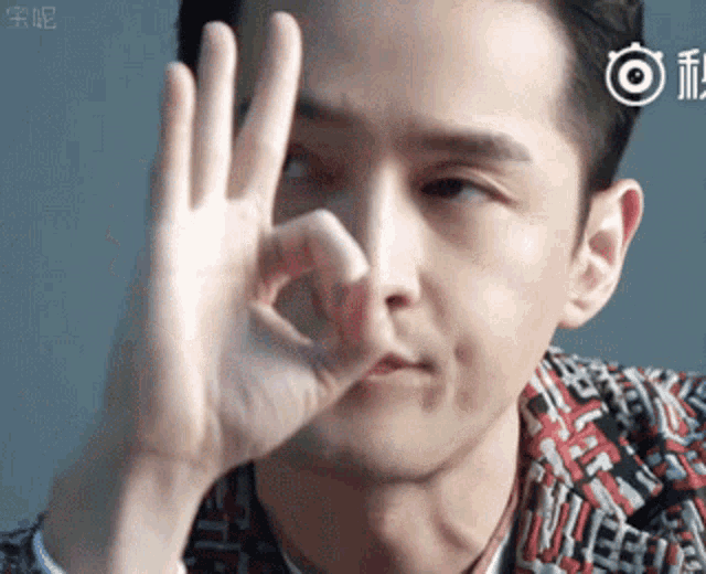 a man is making a ok sign with his hands