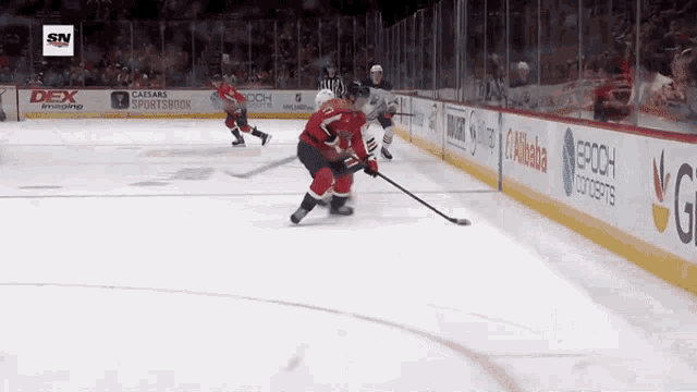 a hockey game is being played in a stadium with advertisements for dex sportsbook and epoch concerts